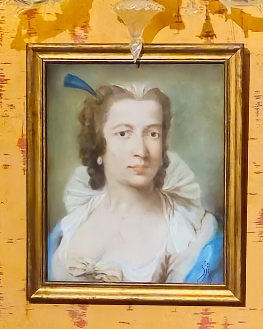 Framed portrait of a woman in a blue dress