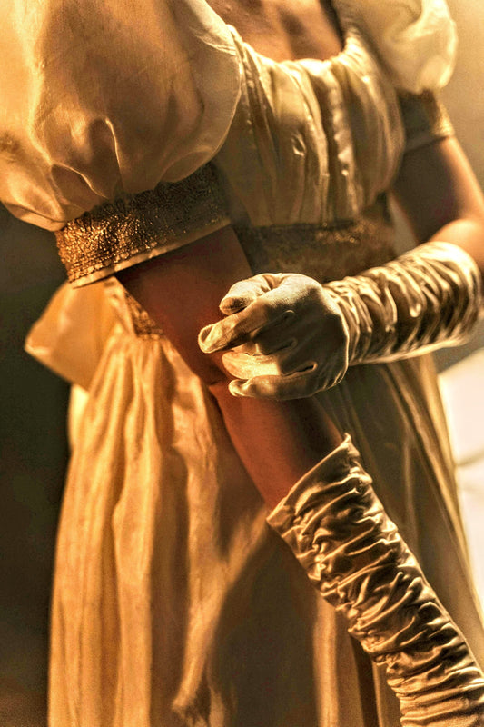 Lady wearing silk gloves and a ballgown