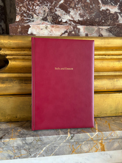 Red ballroom diary album on marble pillar with gold base