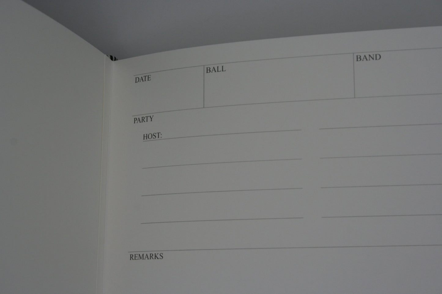 Close up of the writing section of the ballroom diaries, with areas to record the name of the ball, band, date, names of the guests and host and remarks about the ball.