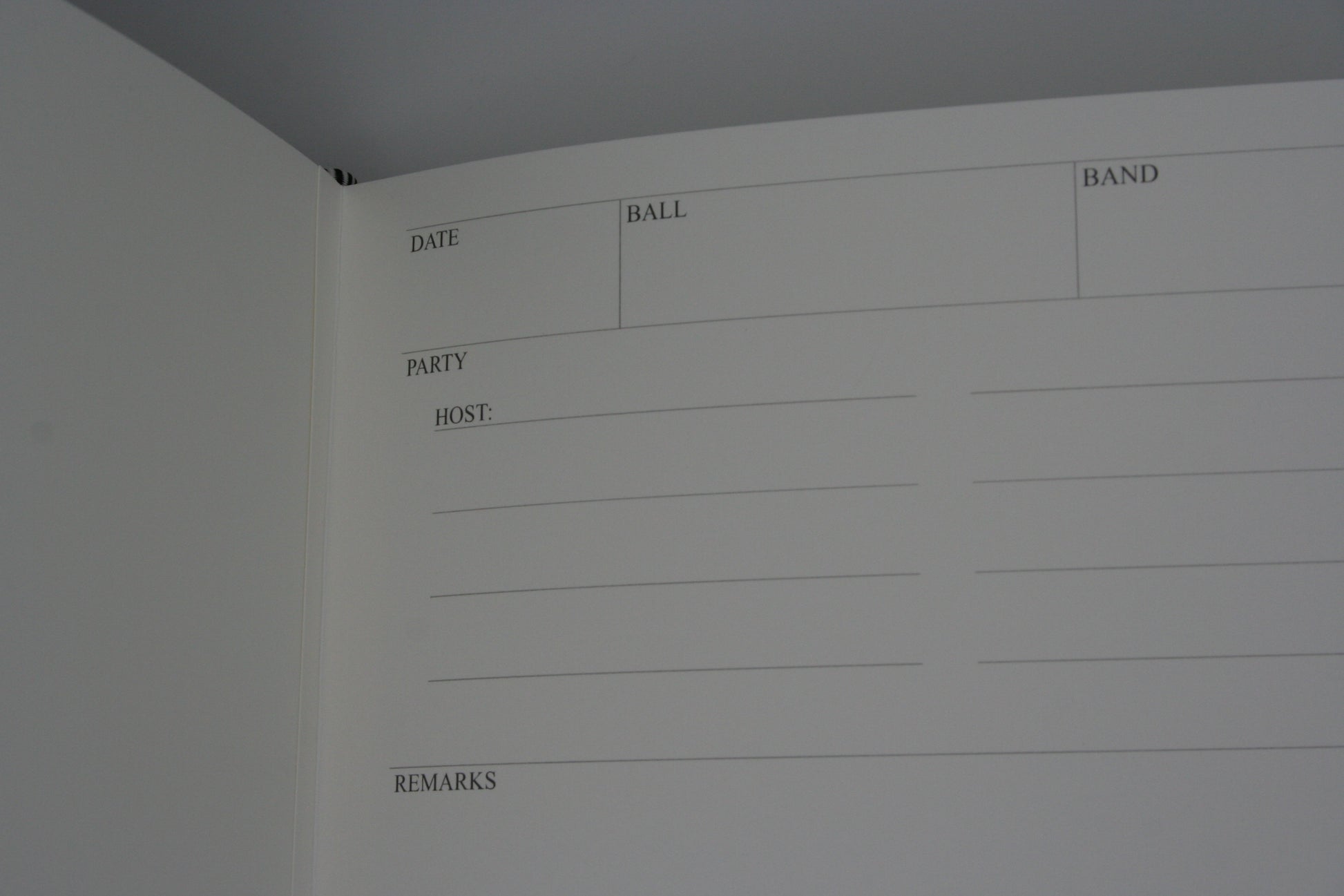 Close up of the writing section of the ballroom diaries, with areas to record the name of the ball, band, date, names of the guests and host and remarks about the ball.