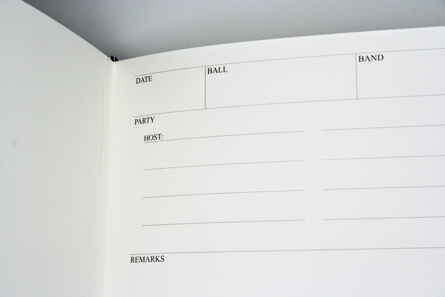 Close-up of a white page of a ballroom diary with text fields for date, ball, band, party, host, and remarks.

